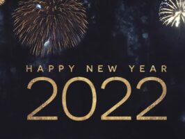 Happy New Year 2022 Text Holiday Graphic with Gold Fireworks Background in Night Sky